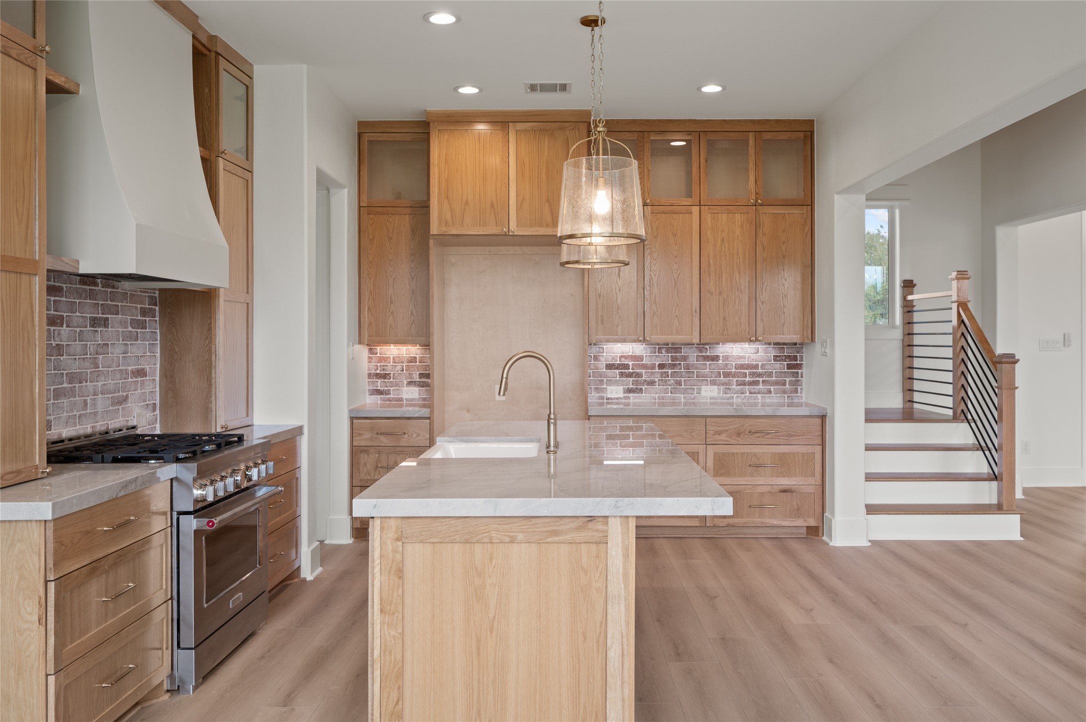 24940 Hopeview Way Montgomery, TX 77356 - Photo 20 of 49 a kitchen with kitchen island wooden cabinets and stove