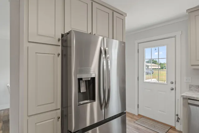 a metallic refrigerator freezer sitting in a kitchen