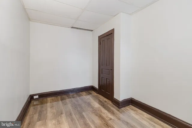 a view of a room with wooden floor