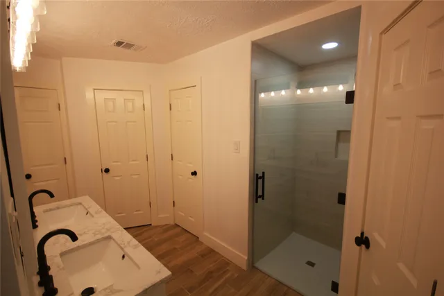 a bathroom with a sink and shower
