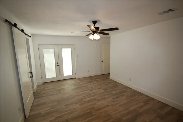 a view of a livingroom with a fireplace a chandelier and wooden floor