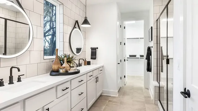 a kitchen with stainless steel appliances kitchen island granite countertop a table chairs and a refrigerator