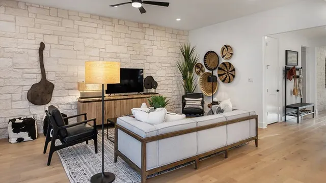 a living room with furniture kitchen view and a potted plant