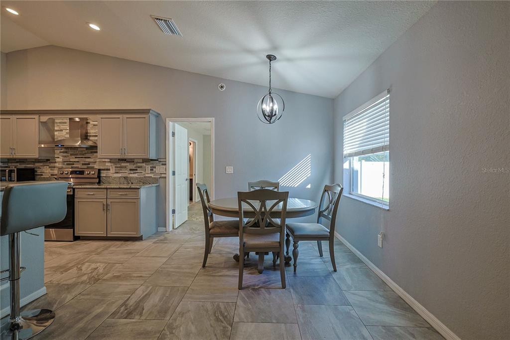 6367 Southwest 117th St Road Ocala, FL 34476 - Photo 11 of 43 a view of a dining room with furniture and chandelier