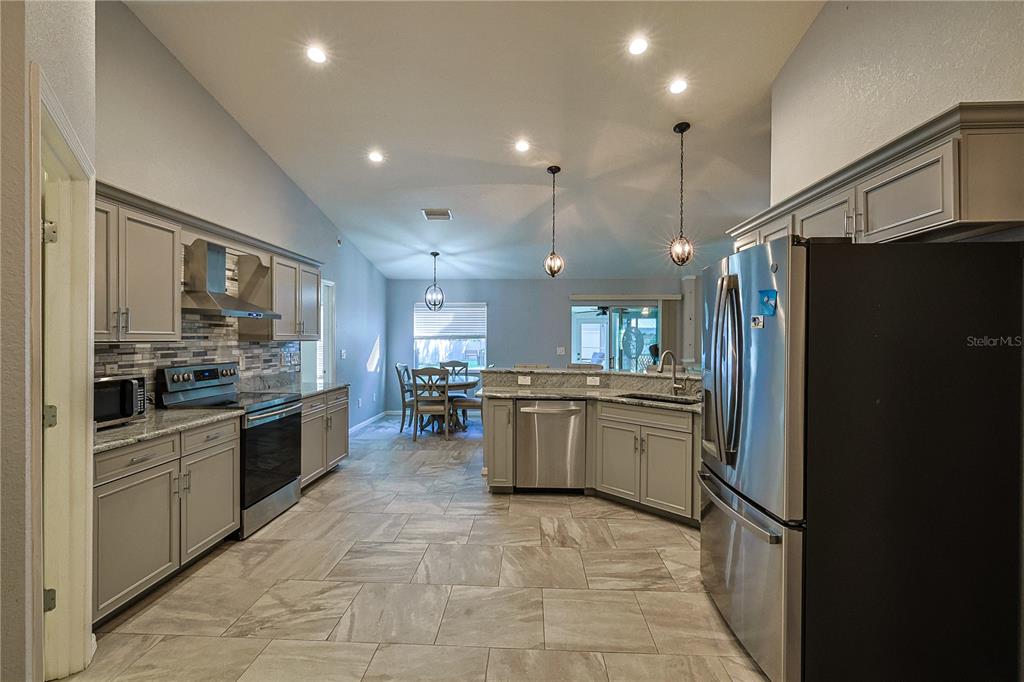 6367 Southwest 117th St Road Ocala, FL 34476 - Photo 15 of 43 a kitchen with a sink stainless steel appliances and cabinets