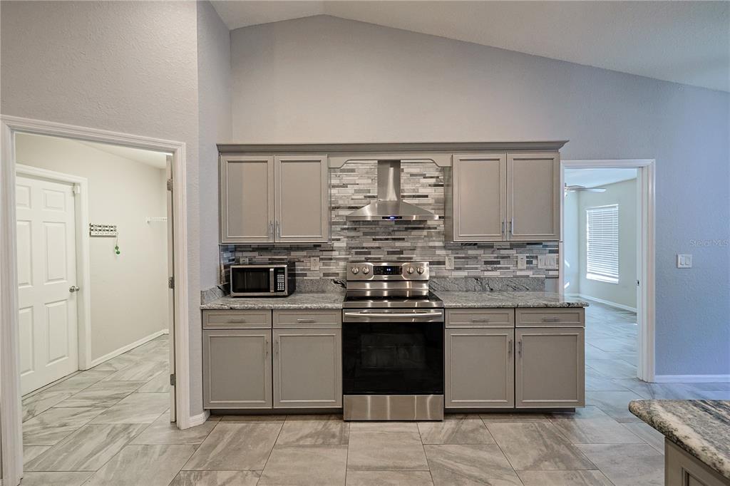 6367 Southwest 117th St Road Ocala, FL 34476 - Photo 16 of 43 a kitchen with a sink stove and cabinets