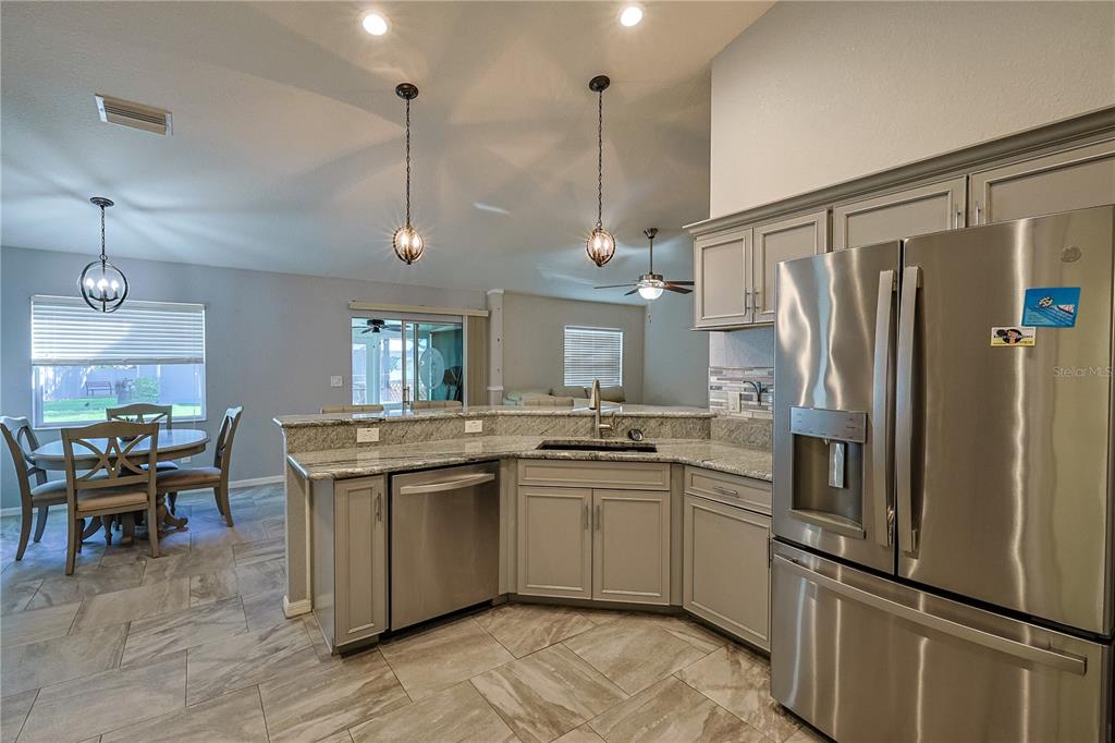 6367 Southwest 117th St Road Ocala, FL 34476 - Photo 17 of 43 a kitchen with stainless steel appliances granite countertop a refrigerator a sink dishwasher a stove and a refrigerator