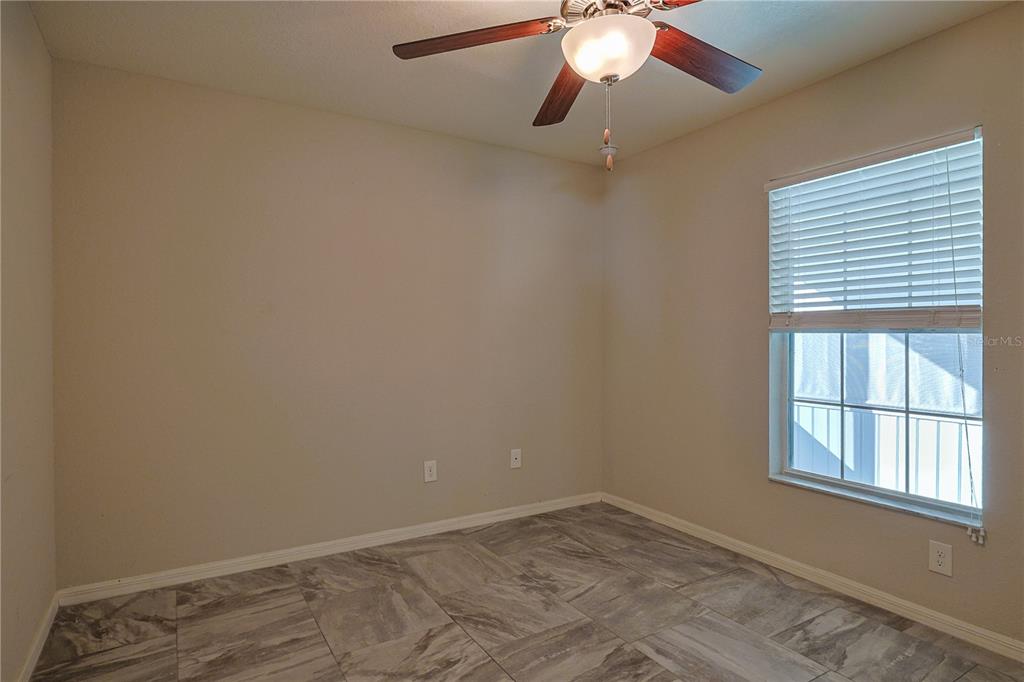6367 Southwest 117th St Road Ocala, FL 34476 - Photo 18 of 43 an empty room with a window and a fan