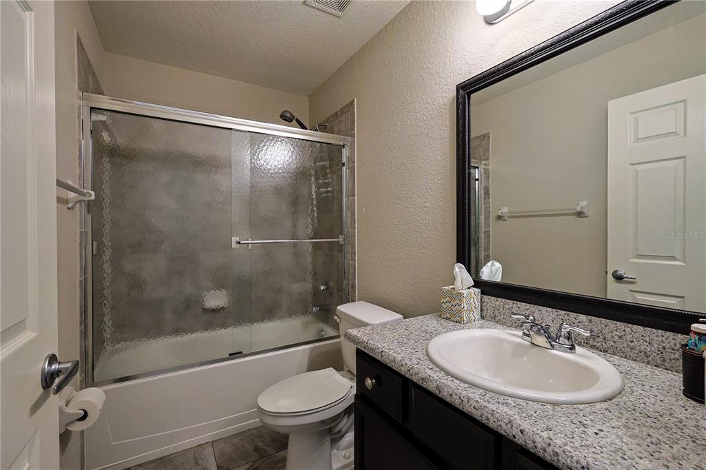 6367 Southwest 117th St Road Ocala, FL 34476 - Photo 20 of 43 a bathroom with a granite countertop sink toilet and shower