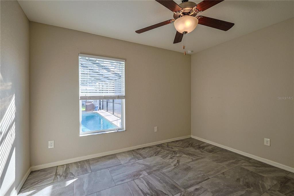 6367 Southwest 117th St Road Ocala, FL 34476 - Photo 21 of 43 an empty room with a window and a fan