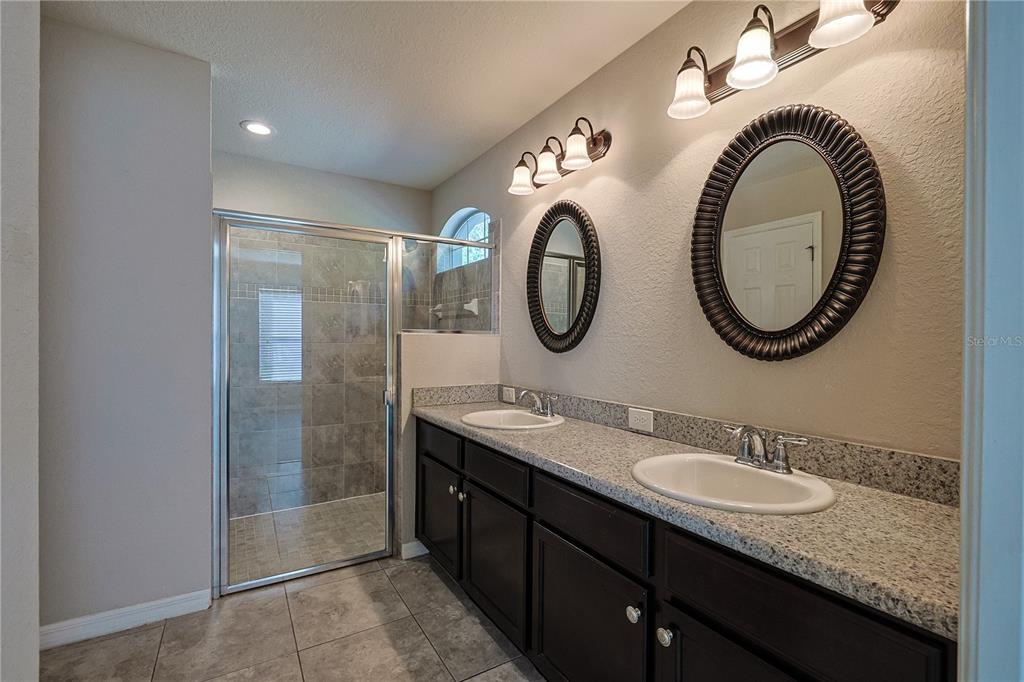 6367 Southwest 117th St Road Ocala, FL 34476 - Photo 26 of 43 a bathroom with a granite countertop sink and a mirror