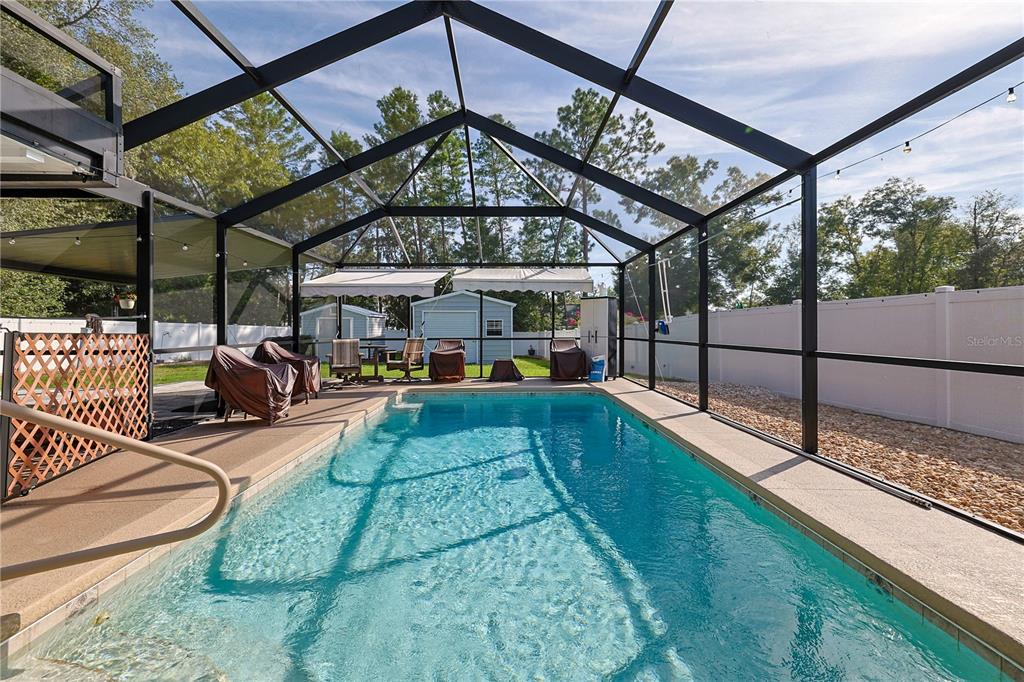 6367 Southwest 117th St Road Ocala, FL 34476 - Photo 32 of 43 a view of a swimming pool with a patio