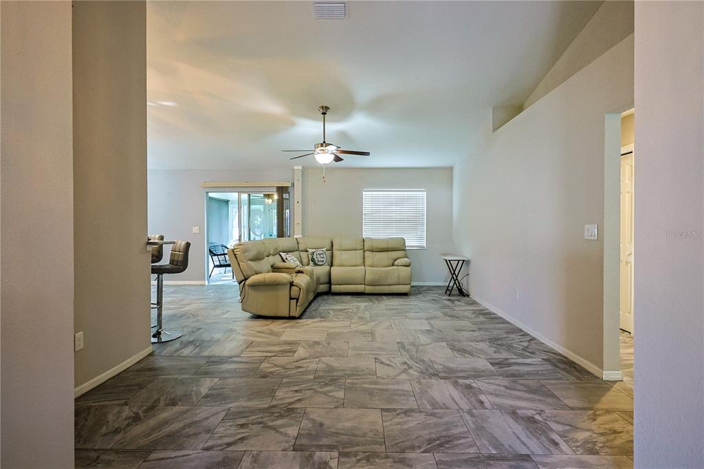 6367 Southwest 117th St Road Ocala, FL 34476 - Photo 8 of 43 a living room with furniture and a chandelier