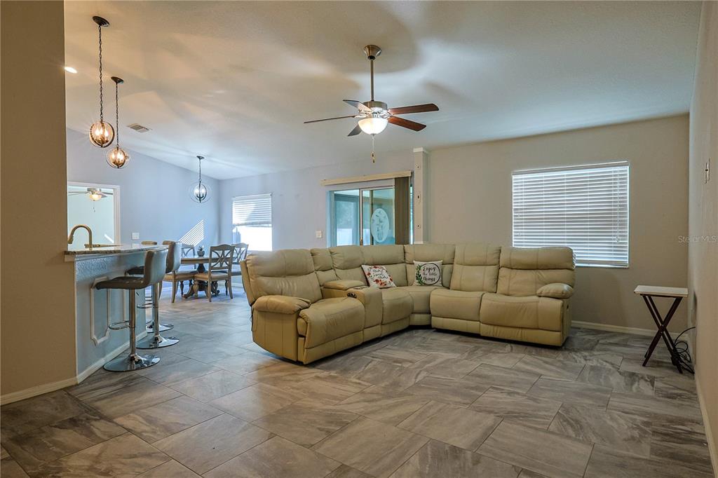 6367 Southwest 117th St Road Ocala, FL 34476 - Photo 9 of 43 a living room with furniture a dining table and a fireplace