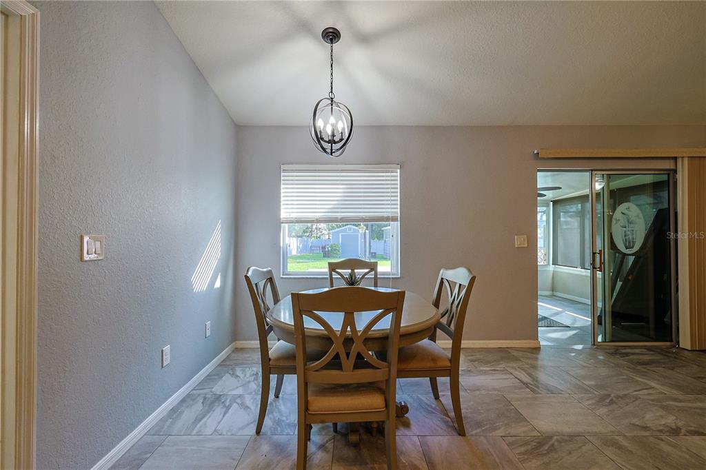6367 Southwest 117th St Road Ocala, FL 34476 - Photo 10 of 43 a view of a dining room with furniture window and wooden floor