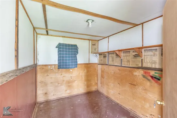 a view of a kitchen with furniture a ceiling fan and wooden floor
