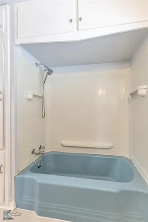 a white toilet sitting next to a bathroom sink