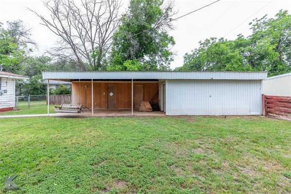 a backyard of a house with yard and outdoor seating