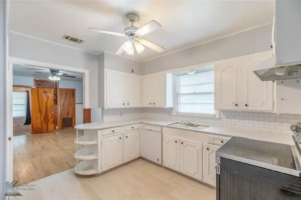 a kitchen with a sink cabinets and window