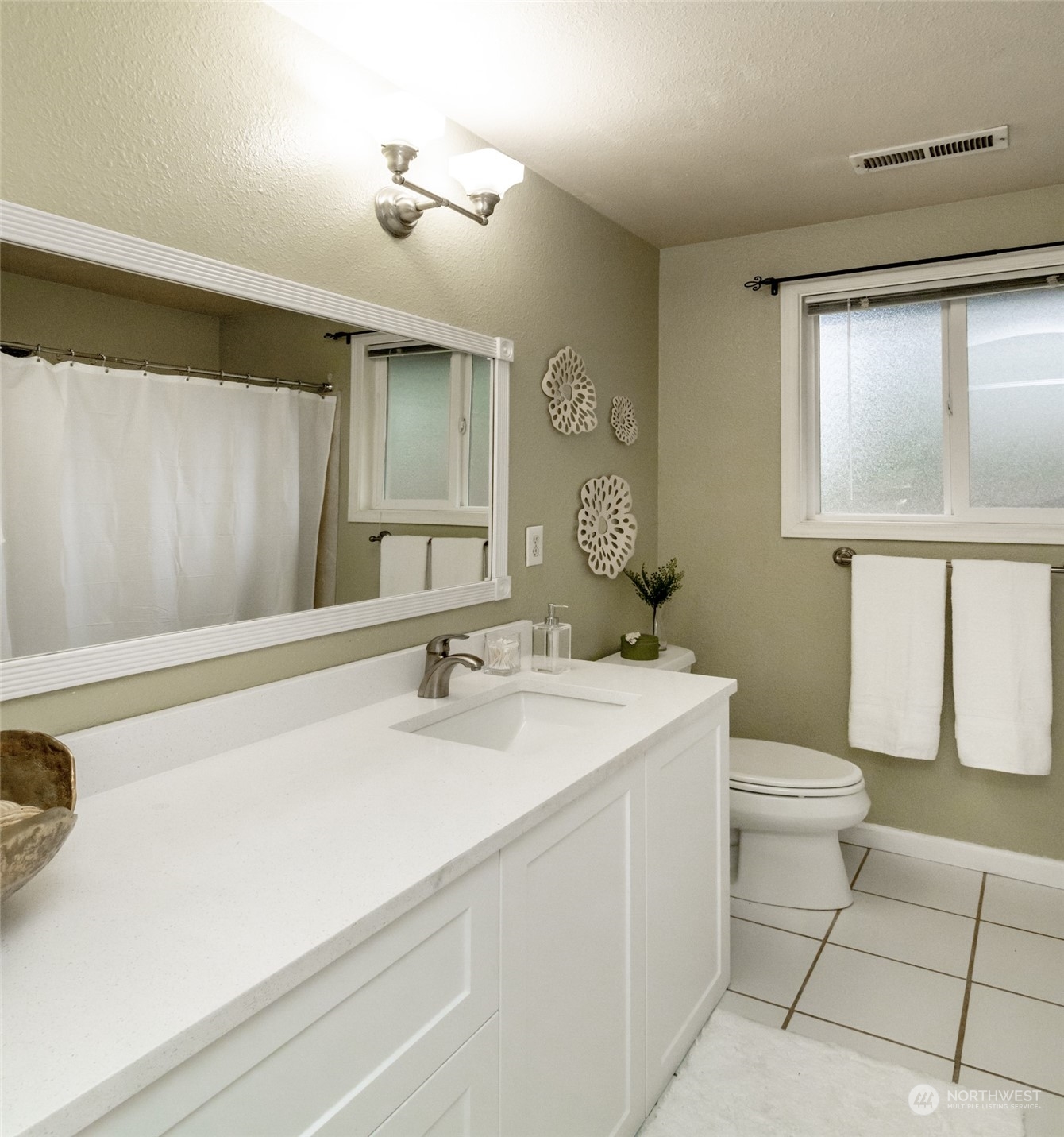 15602 Southeast 178th Street Renton, WA 98058 - Photo 21 of 29 a bathroom with a sink a toilet and mirror