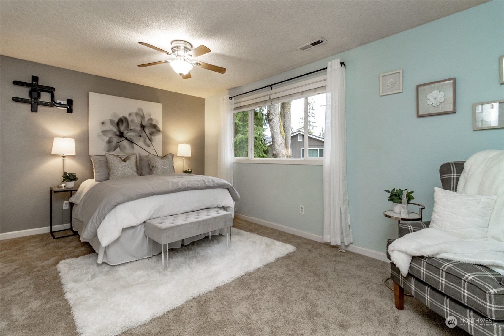 15602 Southeast 178th Street Renton, WA 98058 - Photo 22 of 29 a spacious bedroom with a bed and a chandelier