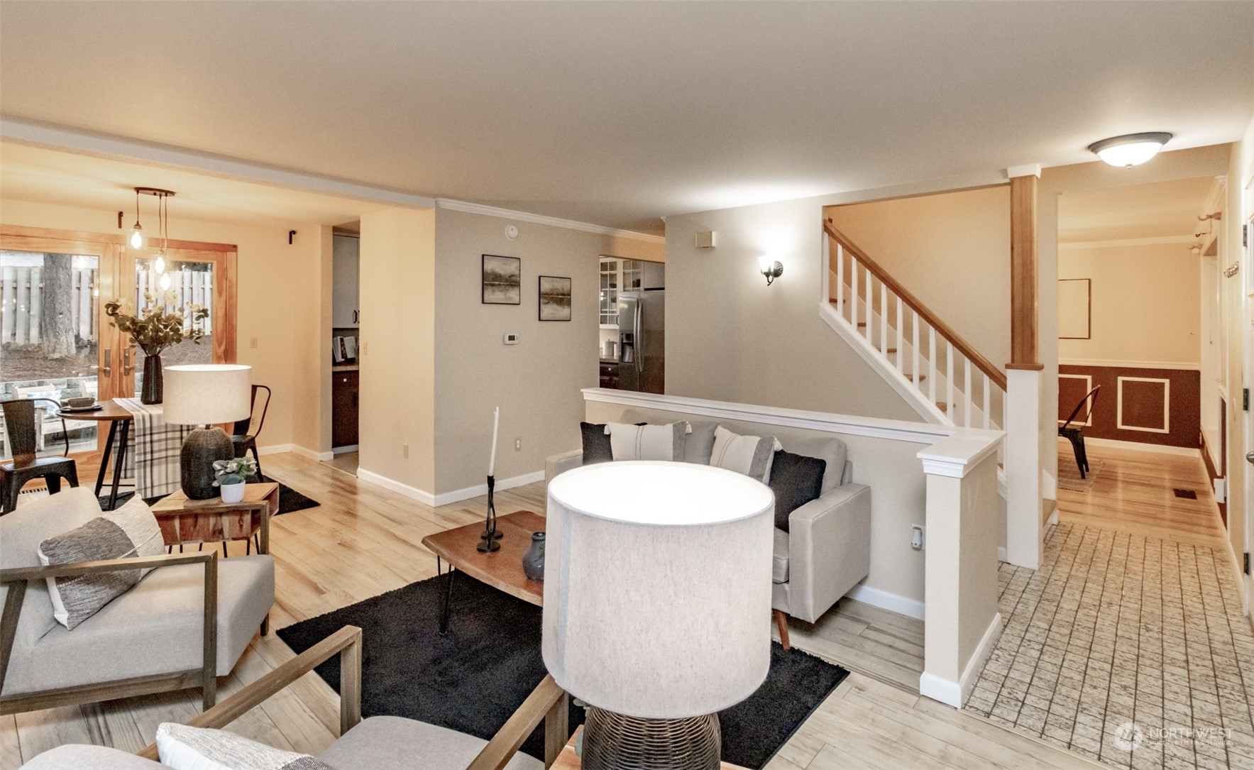 15602 Southeast 178th Street Renton, WA 98058 - Photo 8 of 29 a living room with couches a dining table and chairs with wooden floor