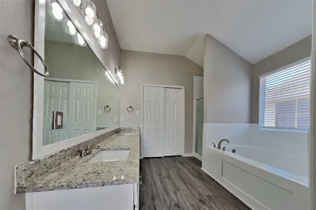 a bathroom with a bathtub and a shower