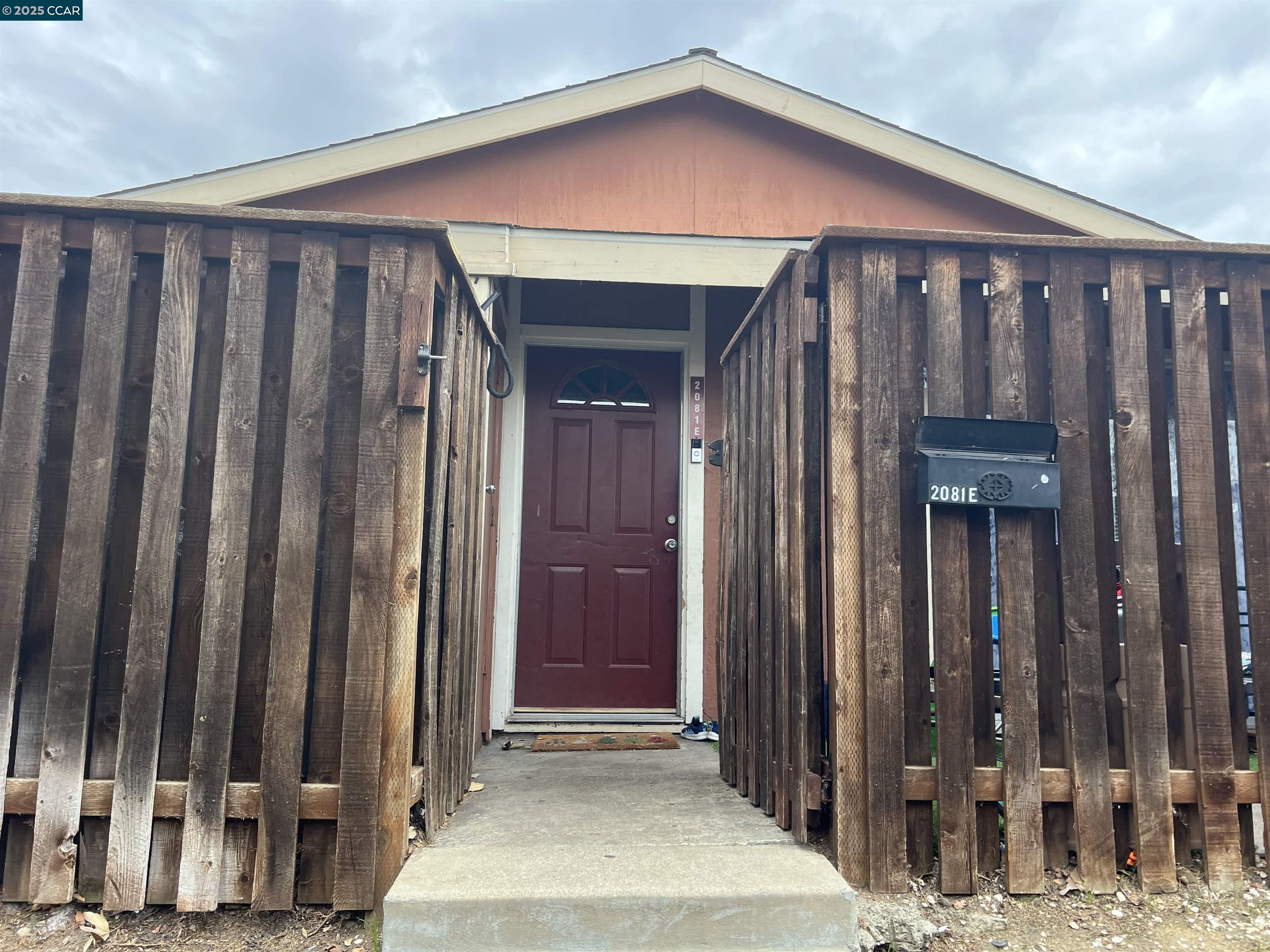 a view of a house with wooden fence