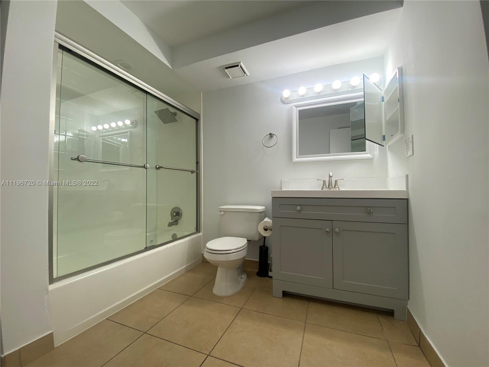 480 Northwest 20th Street, Unit 1030 Boca Raton, FL 33431 - Photo 3 of 16 a bathroom with a toilet sink and shower
