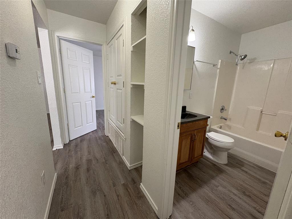 404 South Anglin Street, Unit B Cleburne, TX 76031 - Photo 4 of 12 a bathroom with a sink a toilet and shower