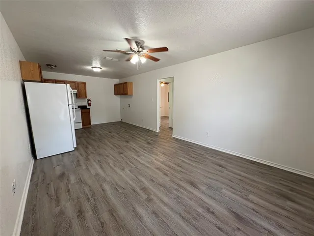 a view of a livingroom with wooden floor and a ceiling fan