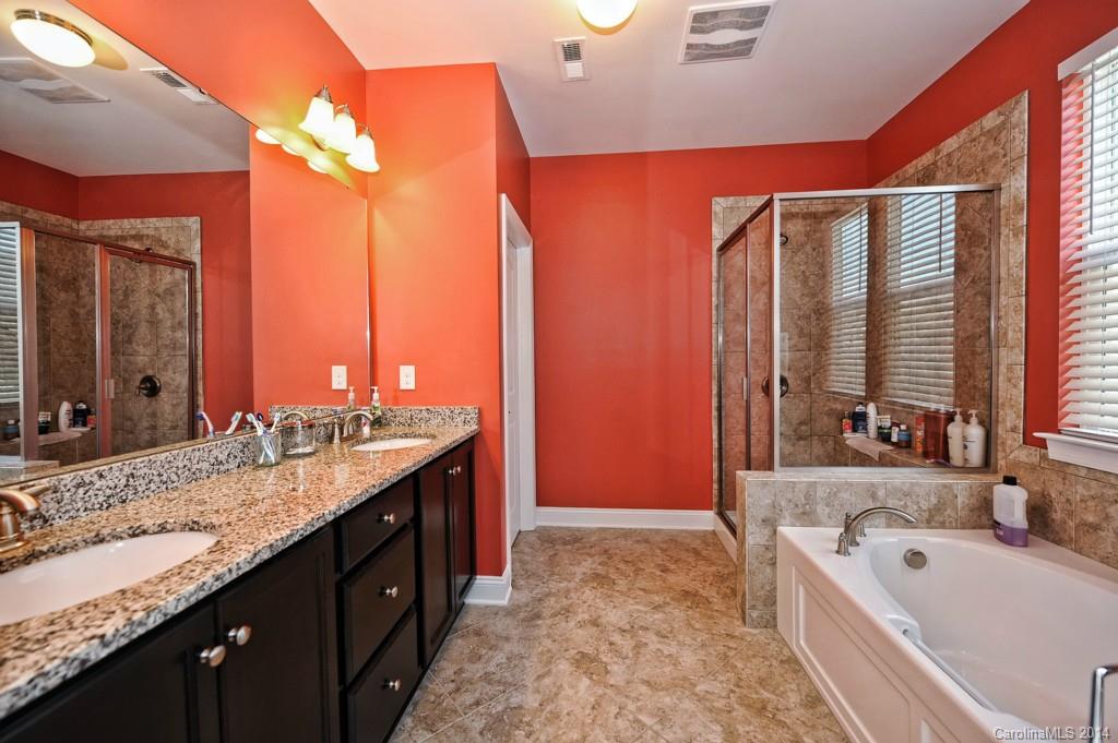 4002 Fallondale Road Waxhaw, NC 28173 - Photo 17 of 24 a bathroom with a granite countertop tub sink and mirror