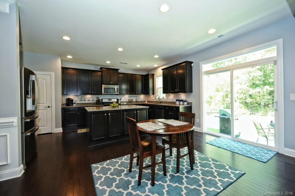4002 Fallondale Road Waxhaw, NC 28173 - Photo 6 of 24 a kitchen with a table chairs refrigerator and microwave