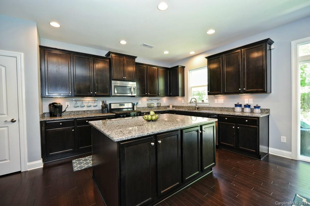 4002 Fallondale Road Waxhaw, NC 28173 - Photo 7 of 24 a kitchen with stainless steel appliances granite countertop a stove refrigerator and a sink