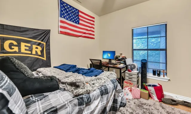 a bedroom with a bed and a book shelf