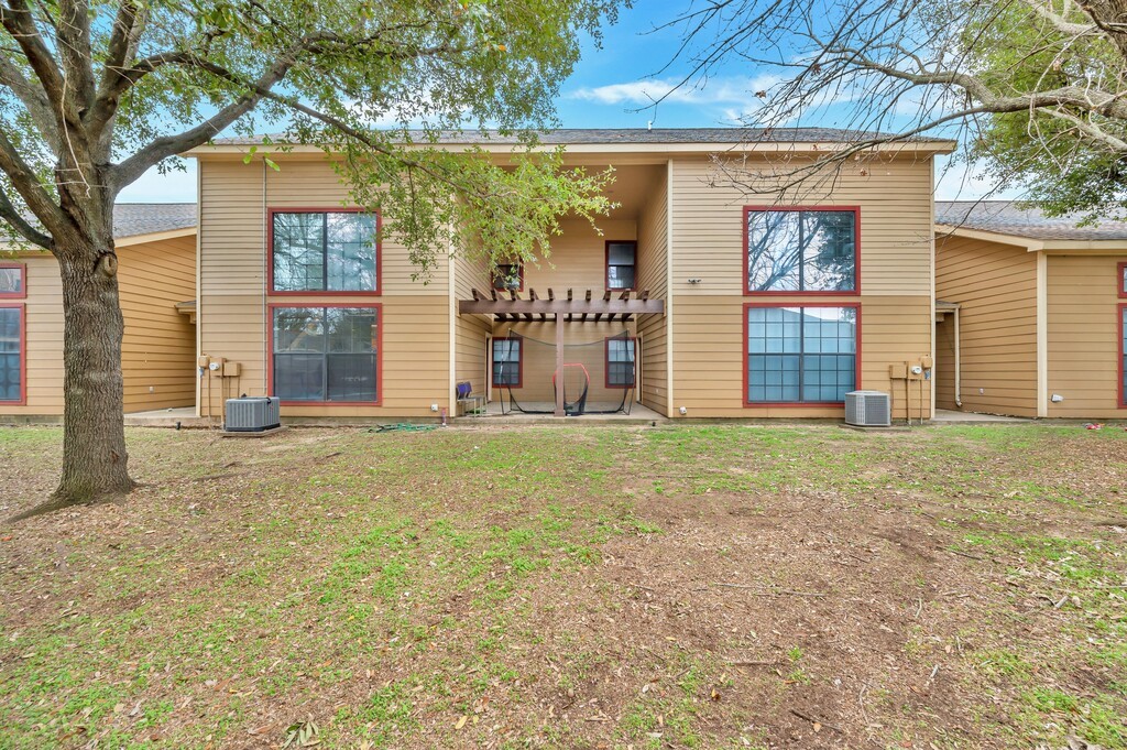 2410 2nd Street South, Unit 1056 Waco, TX 76706 - Photo 27 of 37 a front view of a house with garden