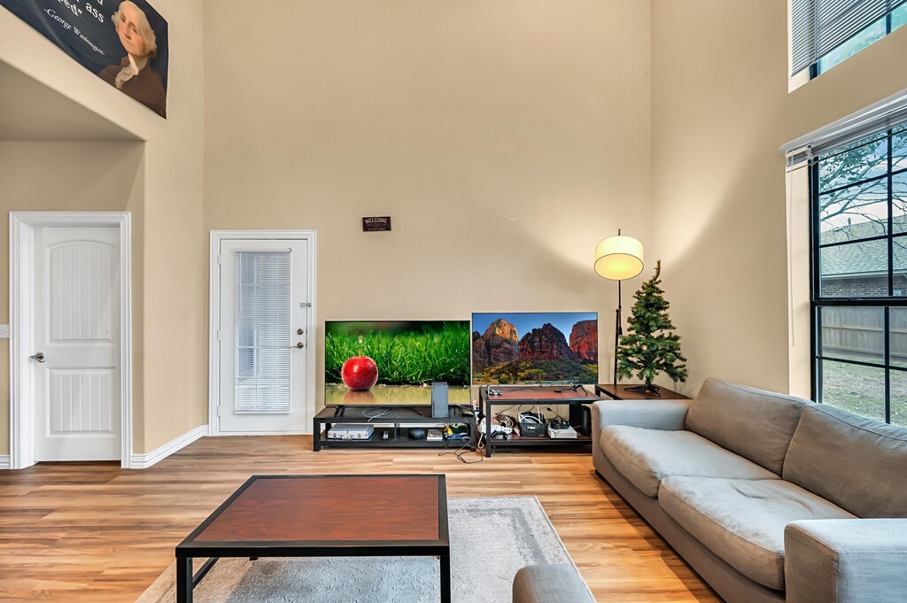 2410 2nd Street South, Unit 1056 Waco, TX 76706 - Photo 7 of 37 a living room with furniture and a flat screen tv