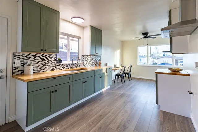 a large kitchen with a wooden floor and cabinets