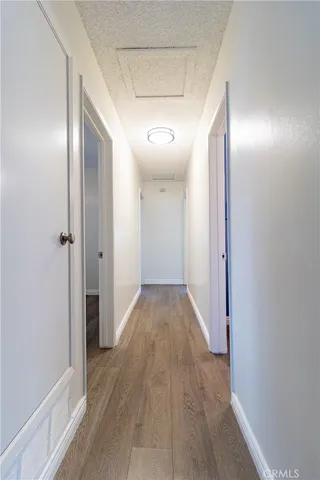 a view of hallway with wooden floor