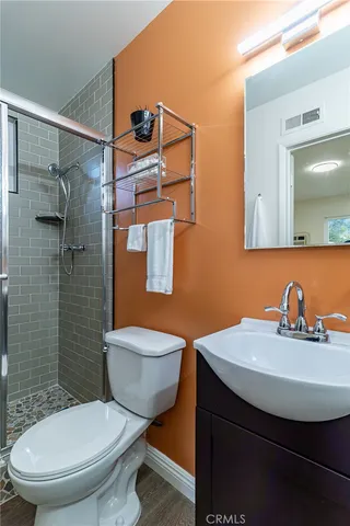 a bathroom with a sink toilet and shower