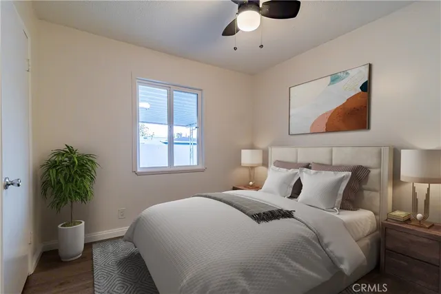 a bedroom with a bed and a potted plant