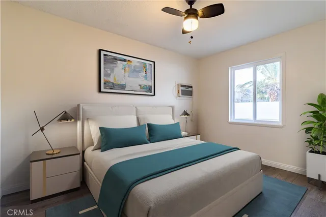 a bedroom with a large bed and a chandelier