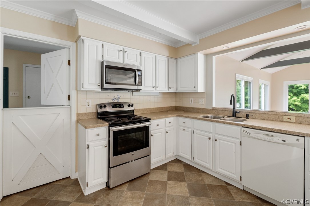 561 Fords Road Manakin-Sabot, VA 23103 - Photo 20 of 33 a kitchen with granite countertop white cabinets and stainless steel appliances