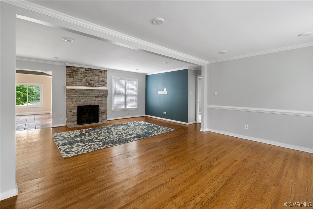 561 Fords Road Manakin-Sabot, VA 23103 - Photo 4 of 33 a view of empty room with wooden floor and fireplace