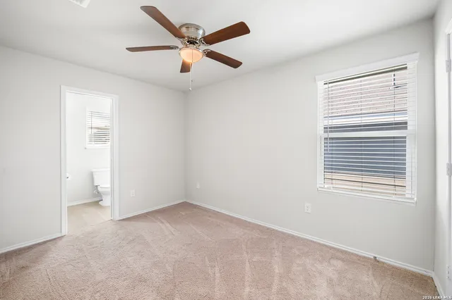 an empty room with a ceiling fan and fan