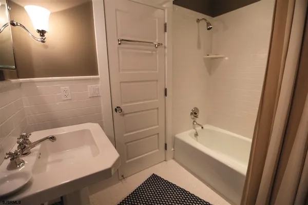 a bathroom with a bathtub and a sink