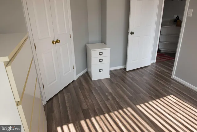 a view of a room with wooden floor and windows