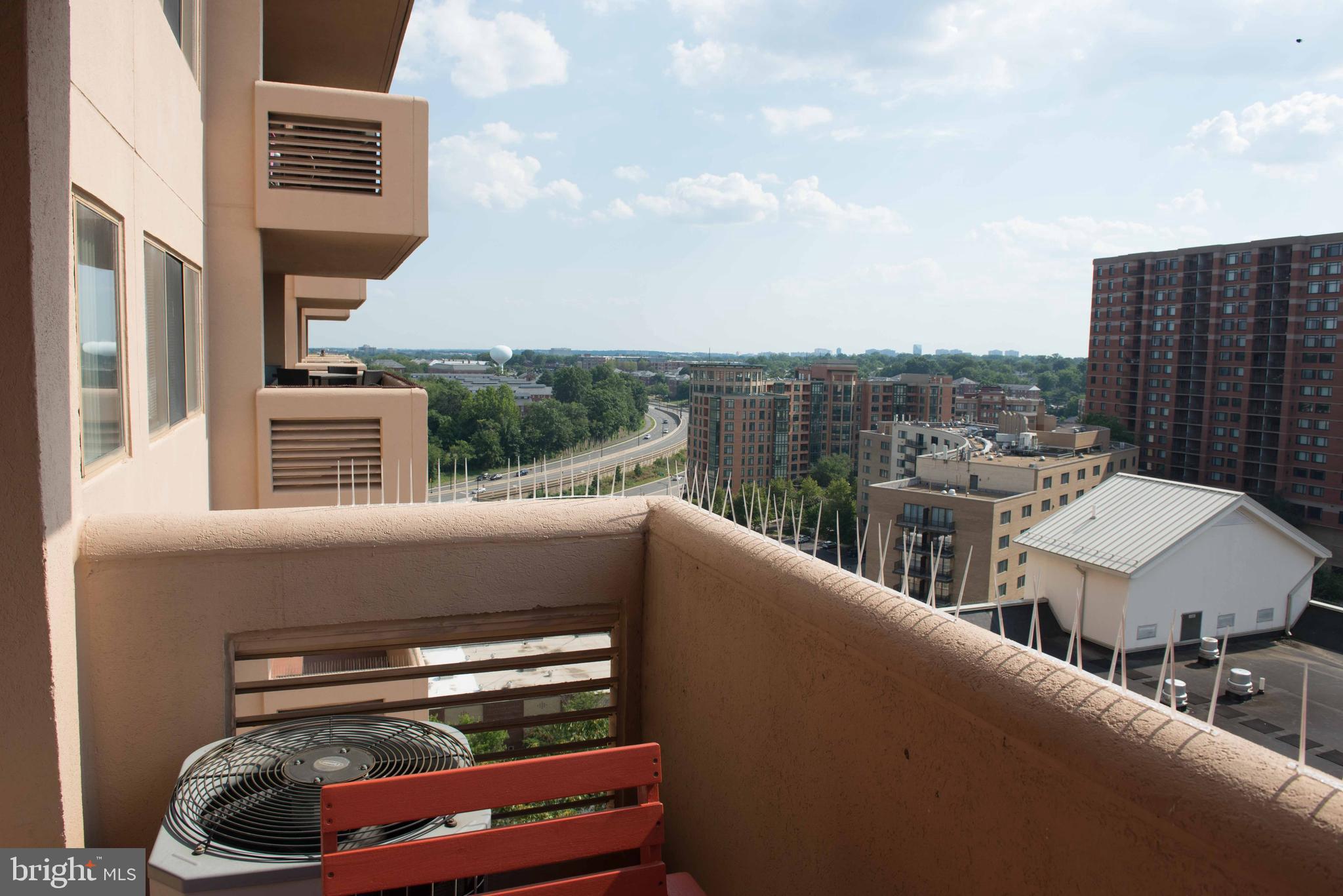 1301 North Courthouse Road, Unit 1507 Arlington, VA 22201 - Photo 32 of 35 a view of a balcony with two chairs and a grill