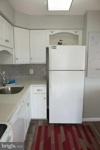a kitchen with a sink and a refrigerator