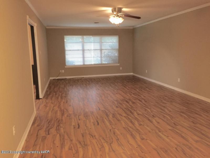 3313 Lombard Road Amarillo, TX 79106 - Photo 4 of 20 an empty room with wooden floor and windows